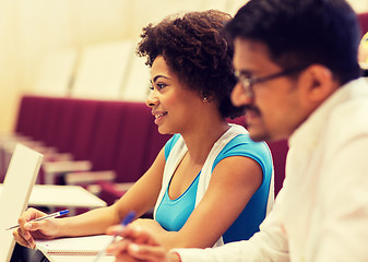 Image showing group of students with notebooks in lecture hall