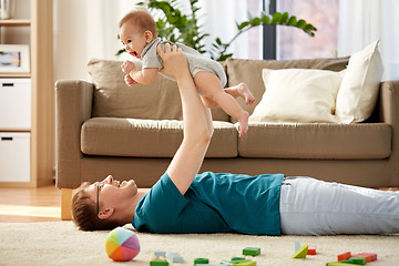 Image showing happy father with little baby son playing at home