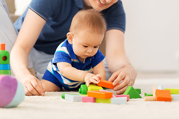 Image showing baby boy with father playing toy blocks at home