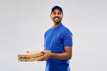 Image showing happy indian delivery man with pizza boxes in blue