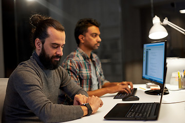 Image showing creative man with smartwatch working at office