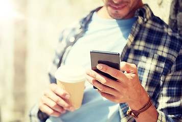 Image showing man with smartphone and coffee on city street