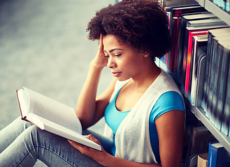 Image showing african student girl reading book at library