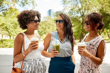 Image showing happy women or friends with drinks at summer park