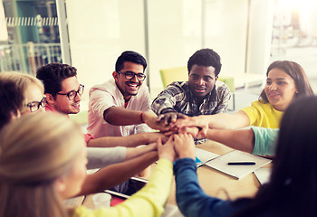 Image showing group of international students with hands on top