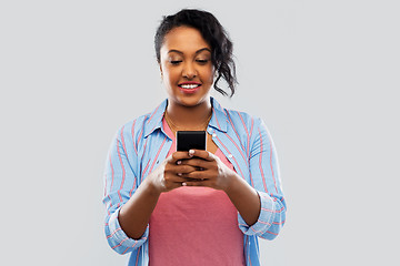 Image showing happy african american woman using smartphone