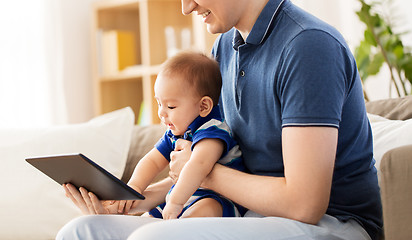 Image showing happy father and baby son with tablet pc at home