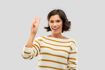 Image showing happy smiling woman showing four fingers