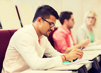 Image showing group of students with notebooks in lecture hall