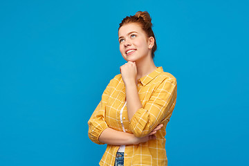 Image showing red haired teenage girl looking up and dreaming