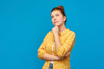 Image showing red haired teenage girl looking up and dreaming