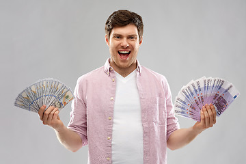 Image showing happy young man with fans of euro and dollar money