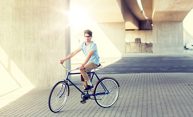 Image showing young hipster man riding fixed gear bike