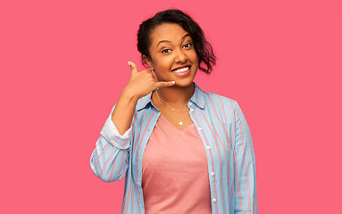 Image showing african american woman making phone call gesture