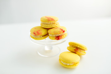 Image showing lemon yellow macarons on glass confectionery stand