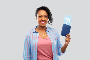 Image showing african woman with passport and air ticket