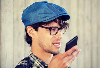 Image showing man recording voice or calling on smartphone