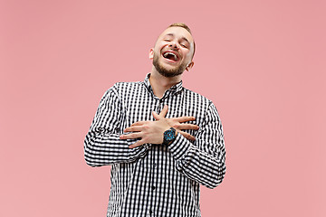 Image showing The happy business man standing and smiling against pink background.