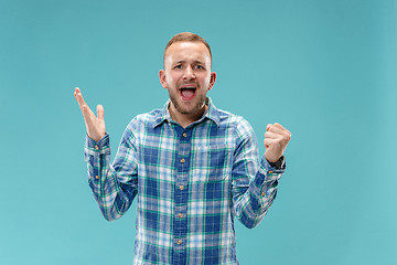 Image showing Beautiful male half-length portrait isolated on blue studio backgroud.