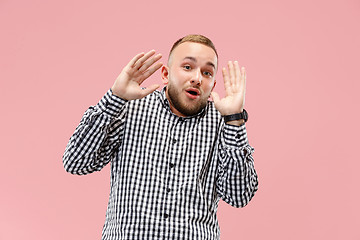 Image showing Portrait of the scared man on pink