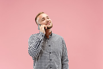 Image showing Young handsome man talking over phone and looking away.