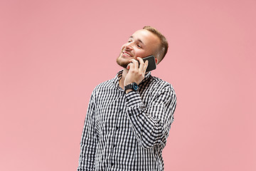 Image showing Young handsome man talking over phone and looking away.