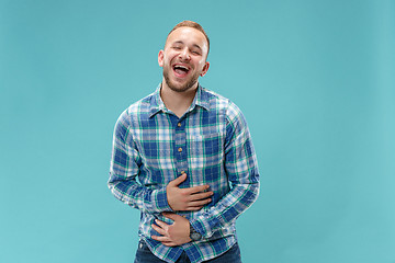 Image showing The happy business man standing and smiling against pink background.