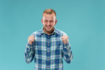 Image showing Beautiful man looking suprised and bewildered isolated on blue