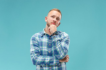 Image showing Young serious thoughtful businessman. Doubt concept.