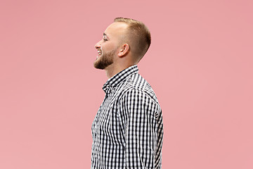 Image showing The happy business man standing and smiling against pink background.