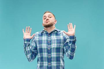 Image showing Beautiful man looking suprised and bewildered isolated on blue