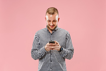 Image showing Young handsome man talking over phone and looking away.