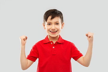 Image showing boy in t-shirt showing fists or winning gesture