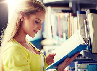 Image showing high school student girl reading book at library