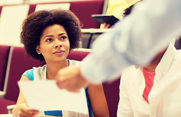 Image showing teacher giving test to student girl on lecture