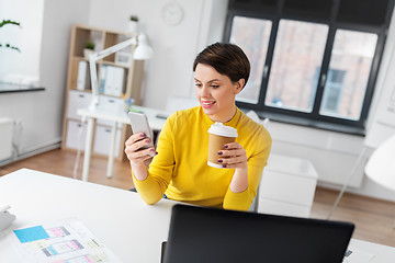 Image showing happy woman with coffee using smartphone at office