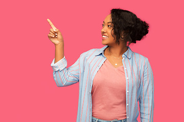 Image showing happy african american woman pointing finger up