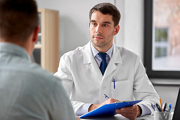 Image showing doctor with clipboard and male patient at hospital