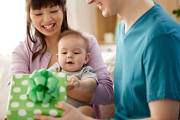 Image showing happy family with baby son and gift at home