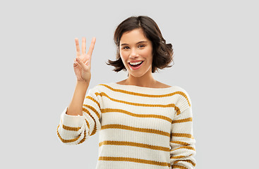 Image showing happy smiling woman showing three fingers