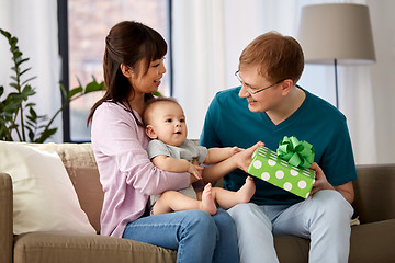 Image showing mother with baby giving birthday present to father