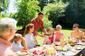 Image showing family having dinner or barbecue at summer garden