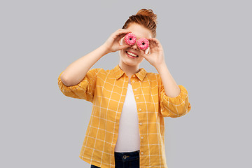 Image showing funny teenage girl with donuts instead of eyes