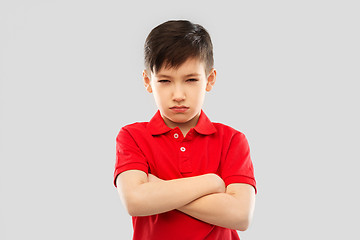 Image showing displeased boy in t-shirt pouting and squinting