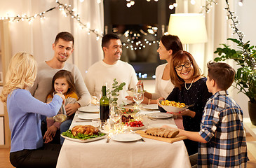 Image showing happy family having dinner party at home