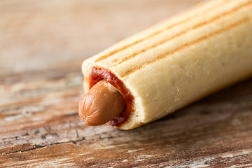 Image showing close up of hot dog on wooden table