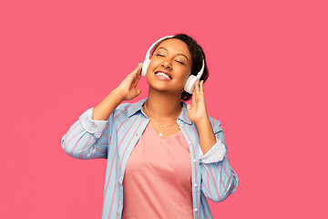 Image showing african woman in headphones listening to music