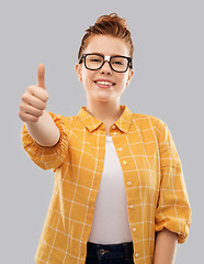 Image showing redhead student girl in glasses showing thumbs up