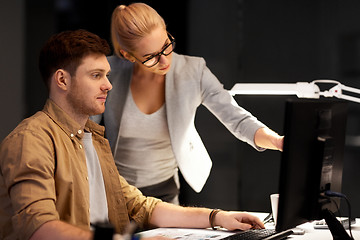 Image showing business team with computer working late at office