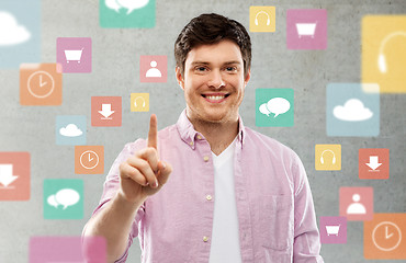 Image showing man showing one finger over app icons on grey